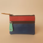 Multicolored zippered pouch with a keychain on a light gray background