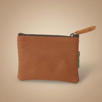 Brown leather pouch with a zipper on a light gray background