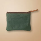 Green leather pouch with a zipper on a light gray background
