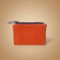 Orange leather wallet with a zipper on a light gray background