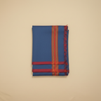 Folded blue fabric with red and orange stripes on a beige background
