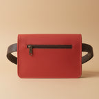 Red leather wallet with a zipper on a light gray background
