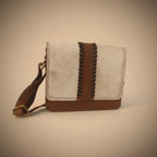 Small leather bag with brown and black accents on a white background