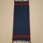 Navy blue fabric with red and gold border on a beige background