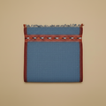 Blue fabric with a red border and pattern on a beige background