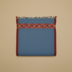 Blue fabric with a red border and pattern on a beige background