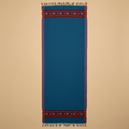 Blue scarf with patterned ends on a beige background