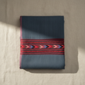 Folded fabric with a red and blue pattern on a beige surface