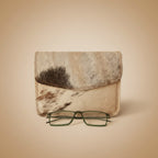 Cowhide leather case with glasses on a light gray background