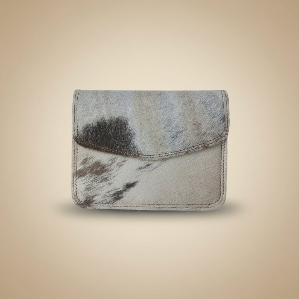 Trifold wallet with cowhide pattern on a light gray background