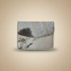 Trifold wallet with cowhide pattern on a light gray background