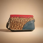Leopard print wallet with red and blue accents on a white background