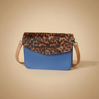 Leopard print strap and blue leather case on a white background