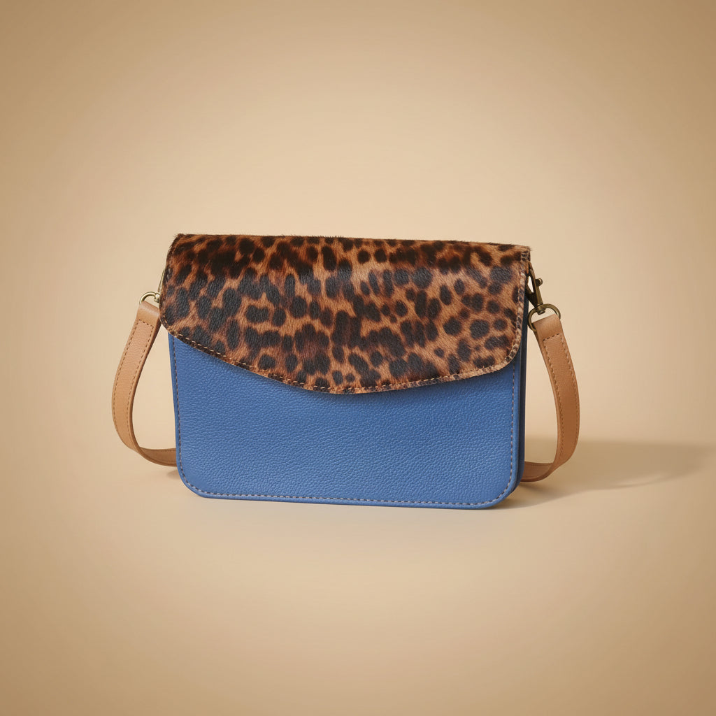 Leopard print strap and blue leather case on a white background