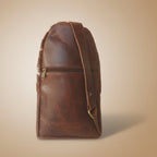 Brown leather bag with strap on a white background